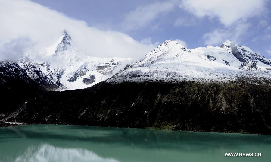 Photo taken on June 2, 2012 shows the Sabu glacier and its glacial lake in Biru County, southwest China's Tibet Autonomous Region. The northern parts of the autonomous region have one of China's richiest glacier distributions, which are increasingly under the threat of global warming. (Xinhua/Chogo) 