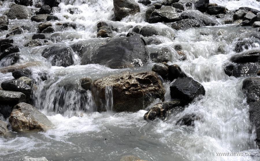 Photo taken on June 2, 2012 shows a glacial river in southwest China's Tibet Autonomous Region. The northern parts of the autonomous region have one of China's richiest glacier distributions, which are increasingly under the threat of global warming. (Xinhua/Chogo) 