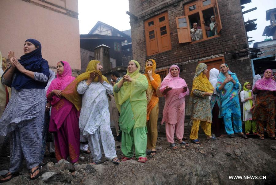 Young Kashmiri Muslim women shout for help as flames engulf the shrine of Sheikh Syed Abdul Qadir Jeelani in Srinagar, summer capital of Indian-controlled Kashmir, June 25, 2012. A 200-year-old Muslim Sufi shrine gutted in a fire incident Monday in Indian-controlled Kashmir, police said. The historical shrine of Sheikh Syed Abdul Qadir Jeelani ( locally called Dastgeer Sahib) is in old part of Srinagar city