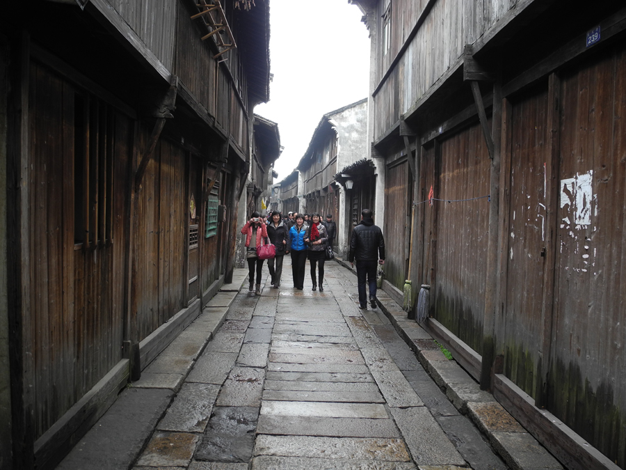 With a history of 1,200-years, Wuzhen is about one hour's drive from Hangzhou, the capital of Zhejiang province. The small town is famous for the ancient buildings and old town layout, where bridges of all sizes cross the streams winding through the town.[Photo by Chen Baojian/China.org.cn]