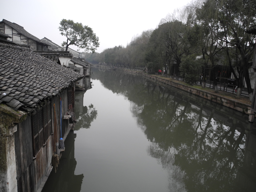 With a history of 1,200-years, Wuzhen is about one hour's drive from Hangzhou, the capital of Zhejiang province. The small town is famous for the ancient buildings and old town layout, where bridges of all sizes cross the streams winding through the town.[Photo by Chen Baojian/China.org.cn]