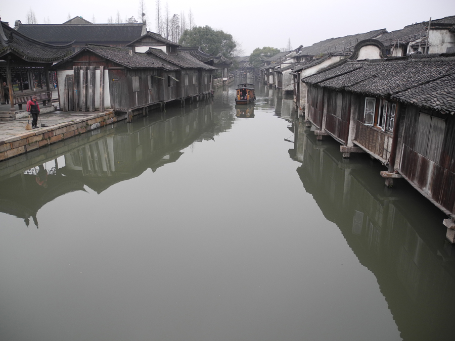 With a history of 1,200-years, Wuzhen is about one hour's drive from Hangzhou, the capital of Zhejiang province. The small town is famous for the ancient buildings and old town layout, where bridges of all sizes cross the streams winding through the town.[Photo by Chen Baojian/China.org.cn]