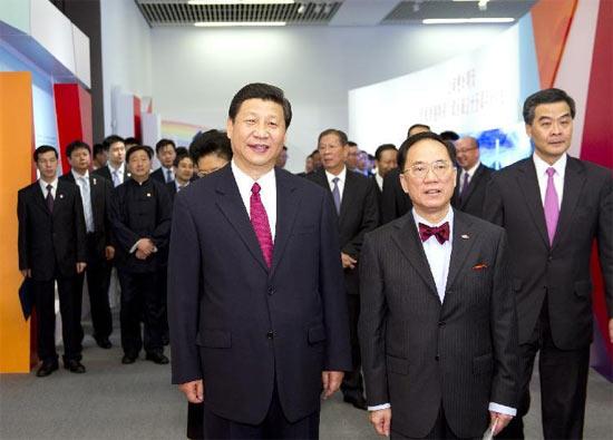 Chinese Vice President Xi Jinping (L, front), also a member of the Standing Committee of the Political Bureau of the Communist Party of China (CPC) Central Committee and vice chairman of the Central Military Commission (CMC), views an exhibition titled 'Towards A Better Future: Achievements In the Fifteen Years Since the Founding of Hong Kong Special Administrative Region' in Beijing, capital of China, June 27, 2012. [Xinhua]
