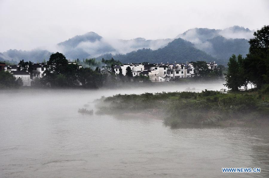 Photo taken on June 27, 2012 shows the fog-surrounded Wuyuan County in east China's Jiangxi Province