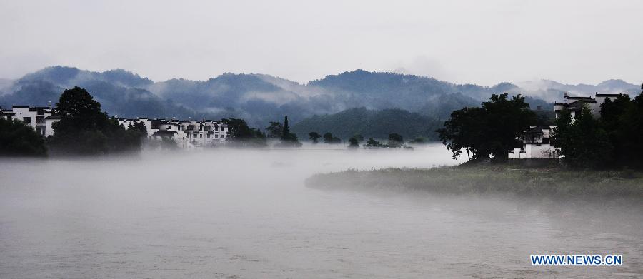 Photo taken on June 27, 2012 shows the fog-surrounded Wuyuan County in east China's Jiangxi Province
