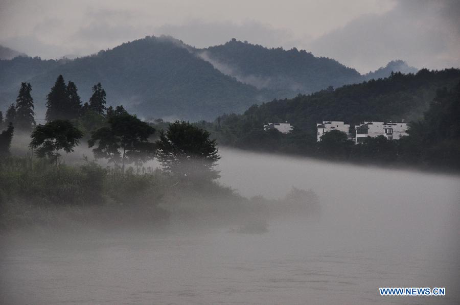 Photo taken on June 27, 2012 shows the fog-surrounded Wuyuan County in east China's Jiangxi Province