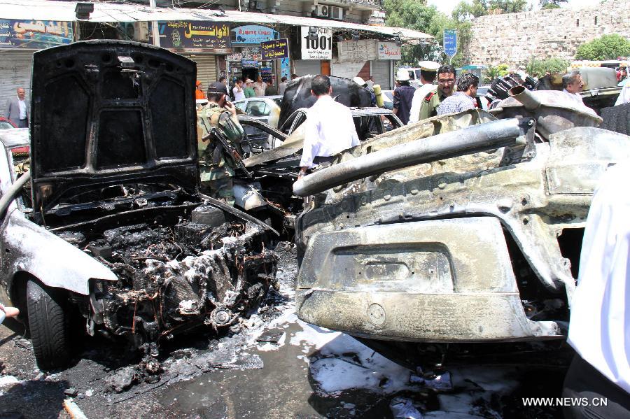 Smashed cars are seen at the site where a strong explosion went off in Damascus, Syria, on June 28, 2012. Syrian state TV says a 'terrorist ' explosion ripped through the parking lot of the Justice Palace in the capital Damascus, injuring three people and smashing 20 parked cars.