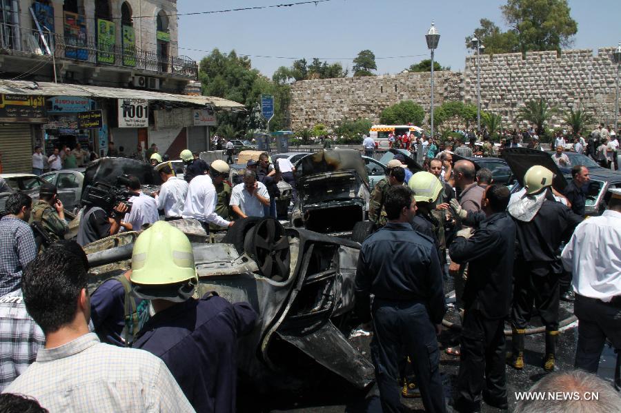 Smashed cars are seen at the site where a strong explosion went off in Damascus, Syria, on June 28, 2012.Syrian state TV says a 'terrorist ' explosion ripped through the parking lot of the Justice Palace in the capital Damascus, injuring three people and smashing 20 parked cars. 