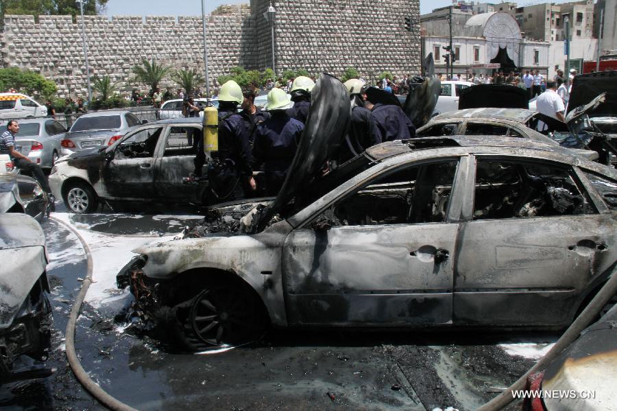 Smashed cars are seen at the site where a strong explosion went off in Damascus, Syria, on June 28, 2012. Syrian state TV says a 'terrorist ' explosion ripped through the parking lot of the Justice Palace in the capital Damascus, injuring three people and smashing 20 parked cars. 