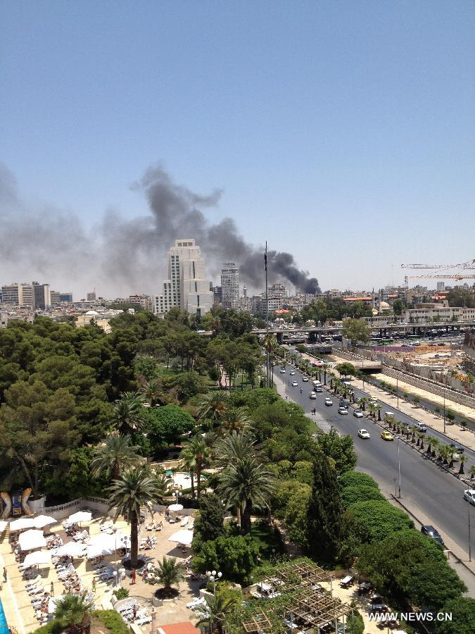 Heavy smoke is seen at Damascus, Syria, on June 28, 2012. Syrian state TV said a 'terrorist' explosion ripped thought the parking lot of the justice place in the capital Damascus. 