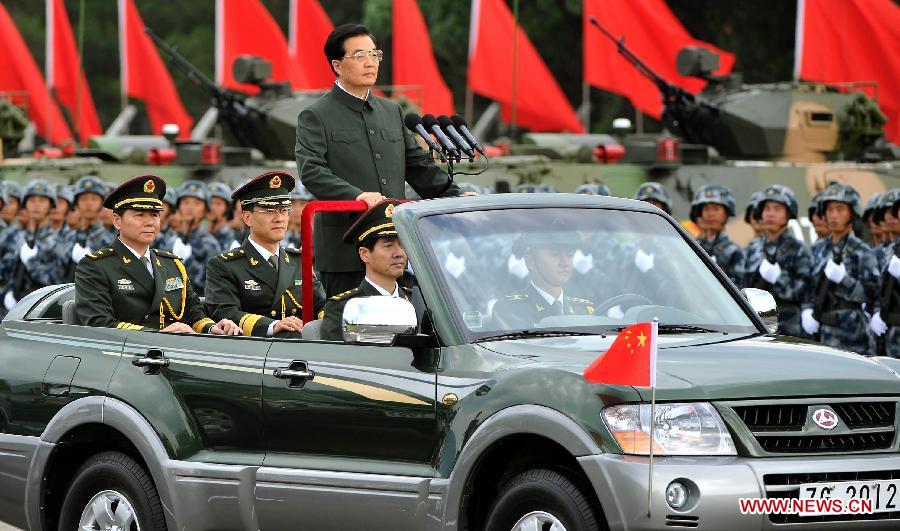 Hu Jintao, general secretary of the Central Committee of the Communist Party of China, Chinese president and chairman of the Central Military Commission, reviews the Chinese People's Liberation Army (PLA) Garrison in the Hong Kong Special Administrative Region (HKSAR), at the Shek Kong barracks in Hong Kong, south China, June 29, 2012.