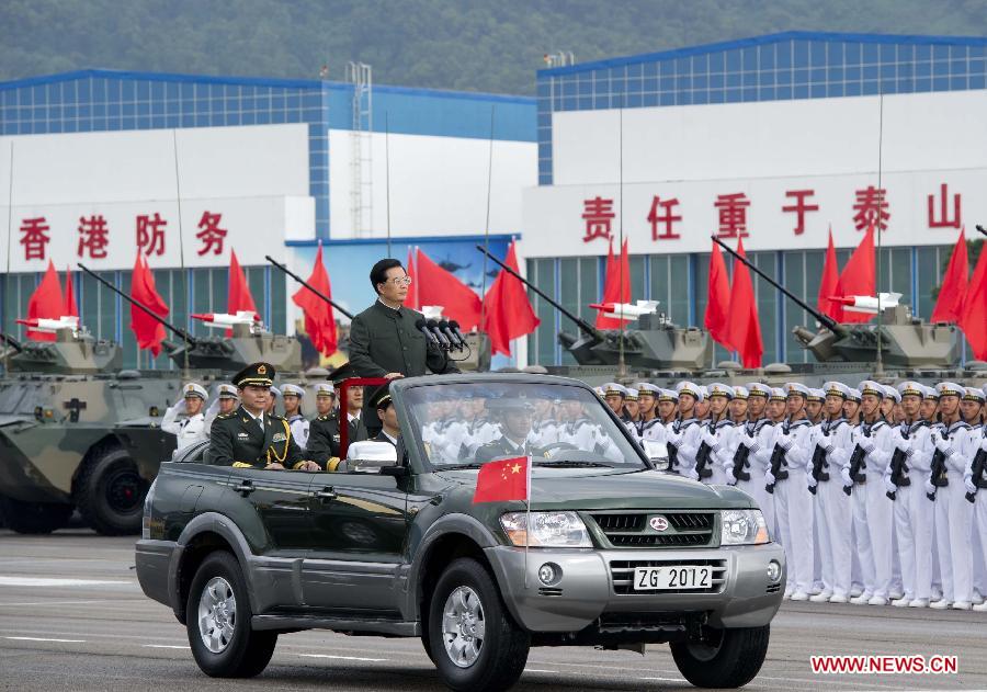 Hu Jintao, general secretary of the Central Committee of the Communist Party of China, Chinese president and chairman of the Central Military Commission, reviews the Chinese People's Liberation Army (PLA) Garrison in the Hong Kong Special Administrative Region (HKSAR), at the Shek Kong barracks in Hong Kong, south China, June 29, 2012.
