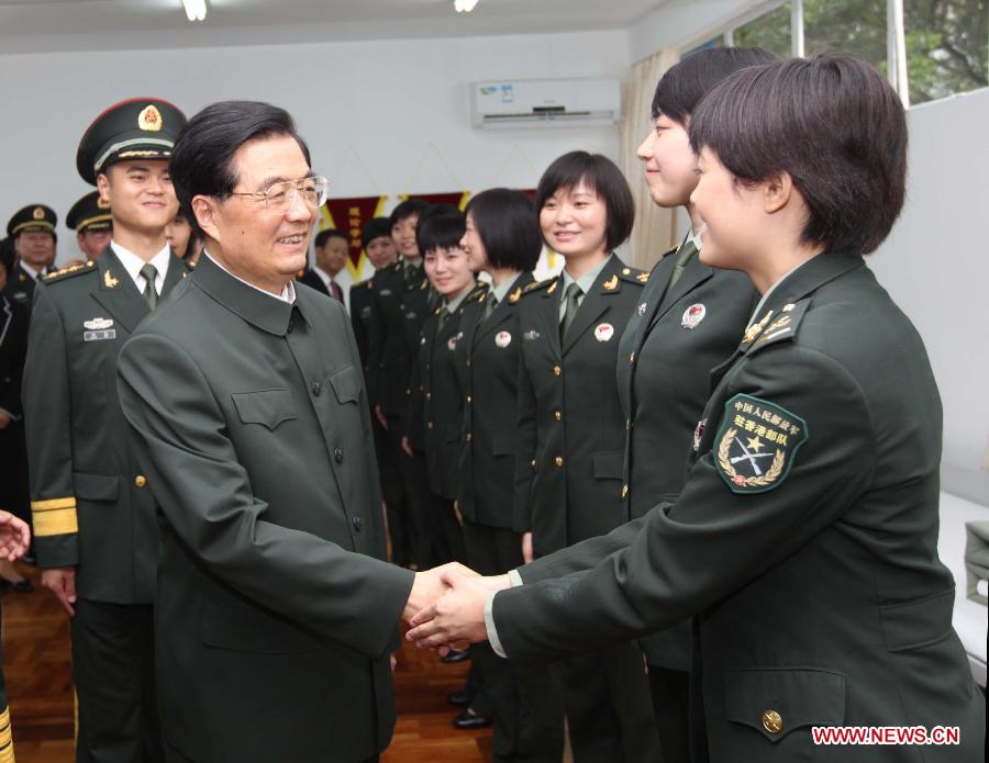 Chinese President Hu Jintao (L, front), who is also general secretary of the Central Committee of the Communist Party of China and chairman of the Central Military Commission, shakes hands with a soldier of the Chinese People's Liberation Army (PLA) Garrison in the Hong Kong Special Administrative Region (HKSAR) at the Shek Kong barracks in Hong Kong, south China, June 29, 2012. 