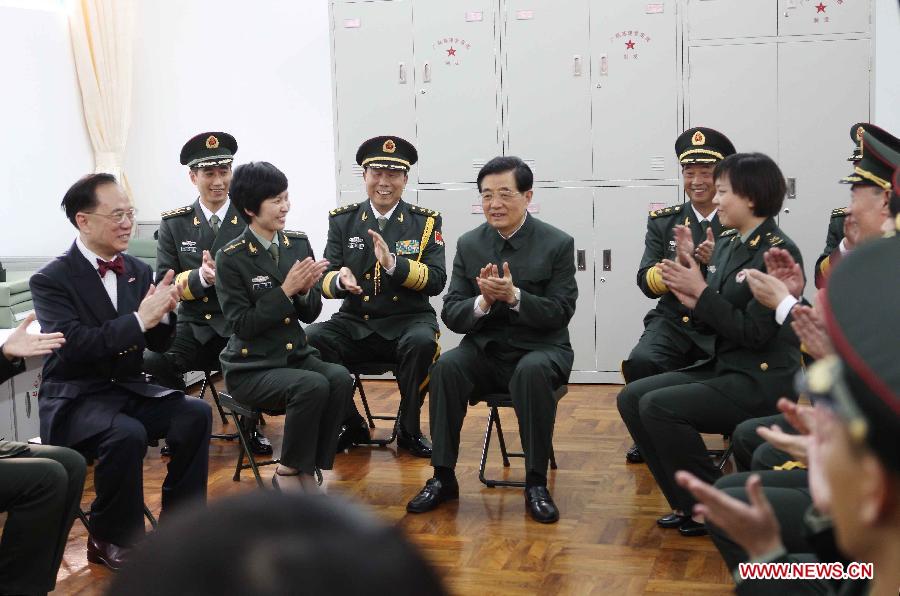 Chinese President Hu Jintao (C), who is also general secretary of the Central Committee of the Communist Party of China and chairman of the Central Military Commission, talks with officers and soldiers of the Chinese People's Liberation Army (PLA) Garrison in the Hong Kong Special Administrative Region (HKSAR), at the Shek Kong barracks in Hong Kong, south China, June 29, 2012.