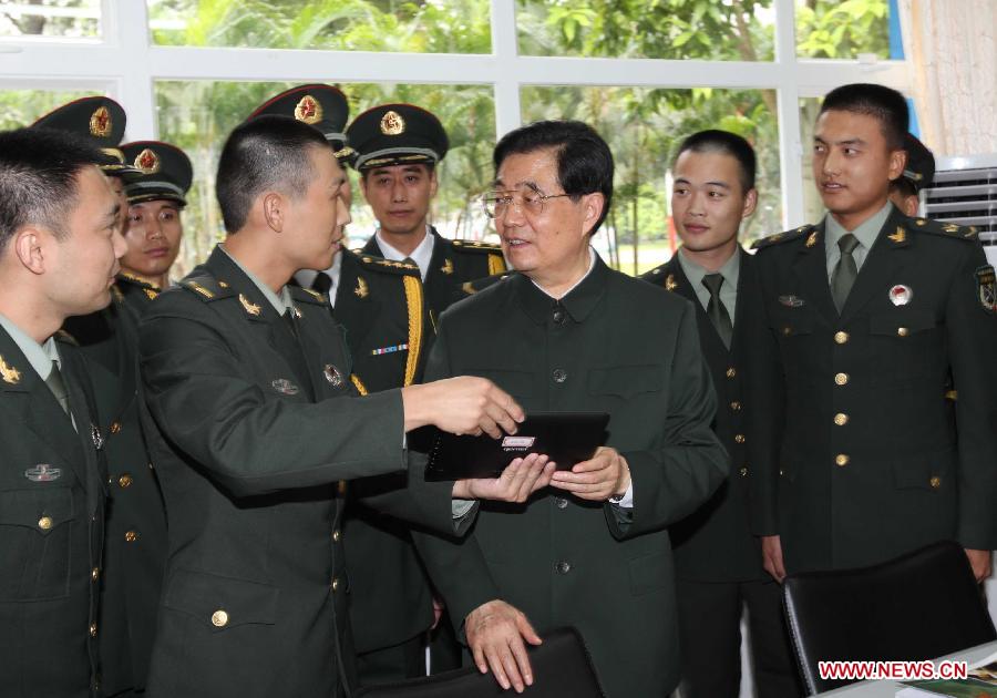 Chinese President Hu Jintao (R, front), who is also general secretary of the Central Committee of the Communist Party of China and chairman of the Central Military Commission, talks with soldiers of the Chinese People's Liberation Army (PLA) Garrison in the Hong Kong Special Administrative Region (HKSAR), at the Shek Kong barracks in Hong Kong, south China, June 29, 2012.