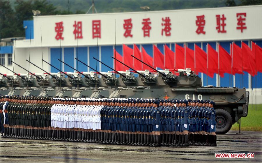 Women soldiers of the Chinese People's Liberation Army (PLA) Garrison in the Hong Kong Special Administrative Region (HKSAR) wait for being inspected by Chinese President Hu Jintao, who is also general secretary of the Central Committee of the Communist Party of China and chairman of the Central Military Commission, at the Shek Kong barracks in Hong Kong, south China, June 29, 2012. 