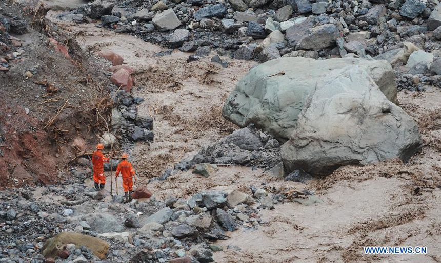Rescuers search for missing people at a construction zone of the Baihetan Hydropower Station in Ningnan county, southwest China&apos;s Sichuan Province, June 29, 2012. At least three people are confirmed dead and 38 others are still missing after a rain-triggered mudslide hit the construction zone Thursday morning.