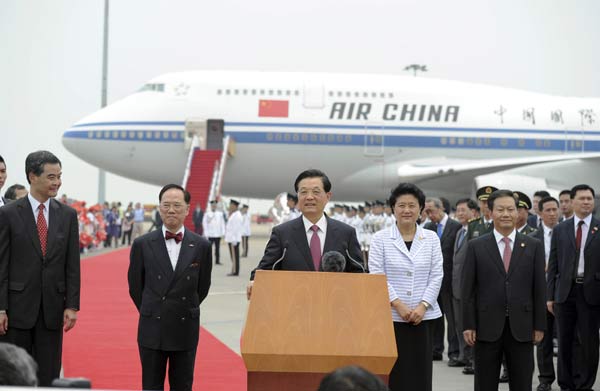 President Hu Jintao (C) delivers a speech upon his arrival at Hong Kong International Airport in Hong Kong June 29. [Xinhua]