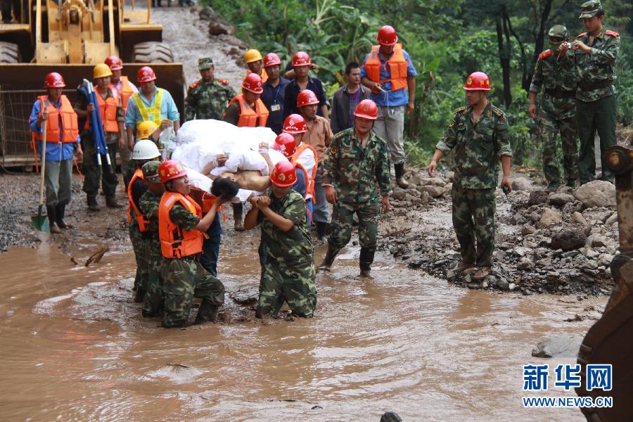 Rescuers search for missing people at a construction zone of the Baihetan Hydropower Station in Ningnan county, southwest China's Sichuan Province, June 29, 2012. At least three people are confirmed dead and 38 others are still missing after a rain-triggered mudslide hit the construction zone Thursday morning. 