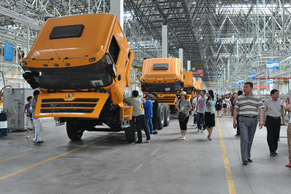 Journalists visit the assembly lines of the Shaanxi Automobile Group Corp. Ltd., Xinjiang Branch on June 28, 2012.