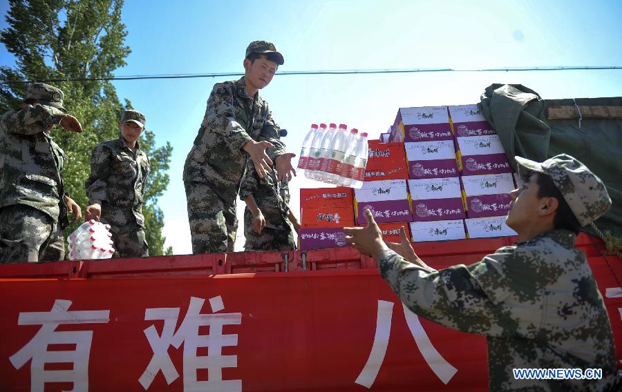 Aid supplies are delivered to quake-affected areas in Xinyuan County of Ili Kazak Autonomous Prefecture, northwest China's Xinjiang Uygur Autonomous Region, July 2, 2012. Up to July 2, 2012, aid supplies valued at over 2 million yuan (about 315,000 U.S dollars) have been donated to Xinyuan County after it was hit by a 6.6-magnitude quake on June 30, 2012. The local government has allocated relief supplies including flour, tents and quilts to the areas. (Xinhua/Jiang Wenyao) 