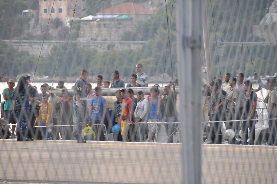 Rescued immigrants stand on a port in Dubrovnik, Croatia, July 2, 2012. 65 immigrants from Syria, Afghanistan, Somalia and Egypt were rescued by Croatian cost guard on Monday and were taken to Dubrovnik. The boat they took was heading to Italy when its engine failed and then drifted off the Croatian Adriatic coast. (Xinhua/Ma Zhen) 