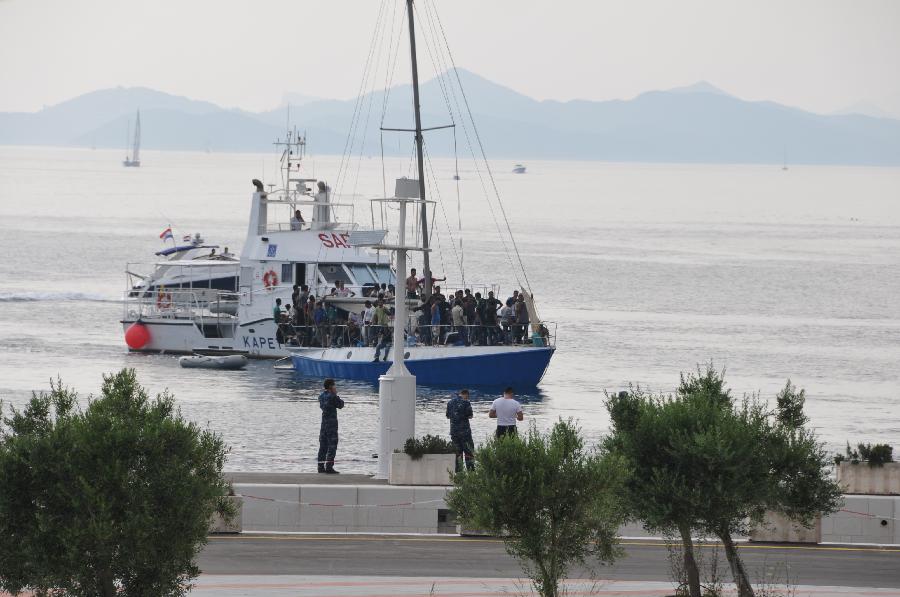 Rescued immigrants wait to disembark in Dubrovnik, Croatia, July 2, 2012. 65 immigrants from Syria, Afghanistan, Somalia and Egypt were rescued by Croatian cost guard on Monday and were taken to Dubrovnik. The boat they took was heading to Italy when its engine failed and then drifted off the Croatian Adriatic coast. (Xinhua/Ma Zhen) 