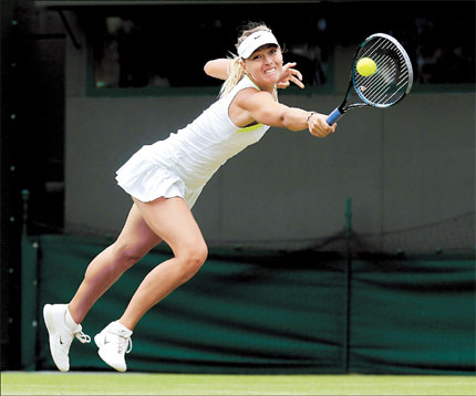 Maria Sharapova of Russia returns a ball to Germany's Sabine Lisicki in a fourth round match at Wimbledon.