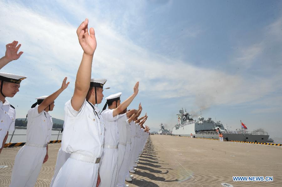 Chinese People's Liberation Army (PLA) Navy soldiers stand guard as the 12th Chinese naval escort flotilla sets sail at a port in Zhoushan, east China's Zhejiang Province, July 3, 2012