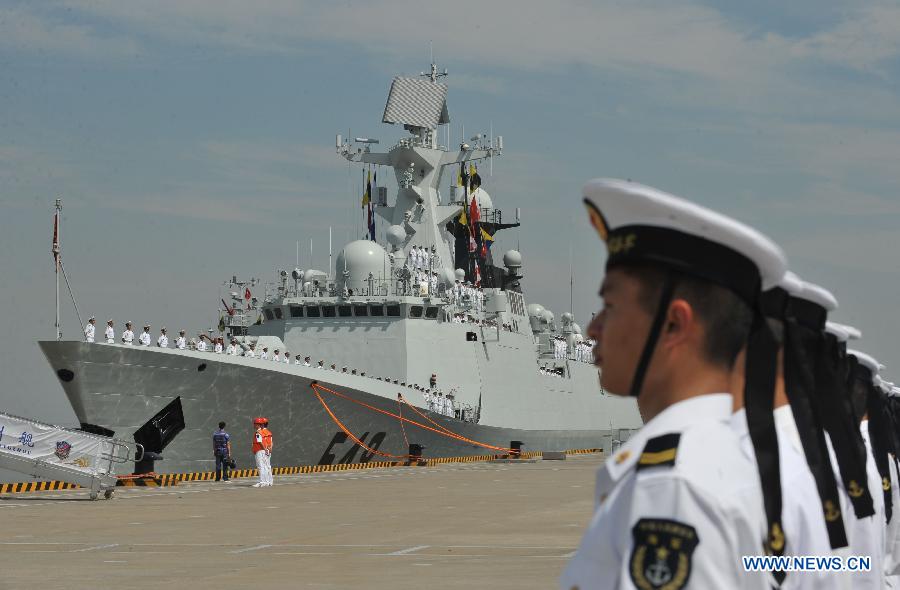 Chinese People's Liberation Army (PLA) Navy soldiers stand guard as the 12th Chinese naval escort flotilla sets sail at a port in Zhoushan, east China's Zhejiang Province, July 3, 2012