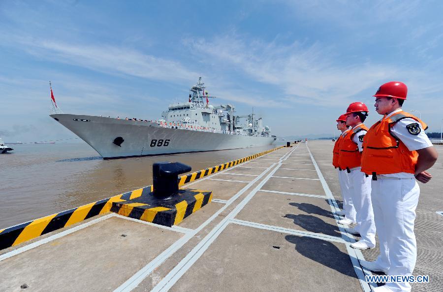 Chinese People's Liberation Army (PLA) Navy soldiers stand guard as the 12th Chinese naval escort flotilla sets sail at a port in Zhoushan, east China's Zhejiang Province, July 3, 2012