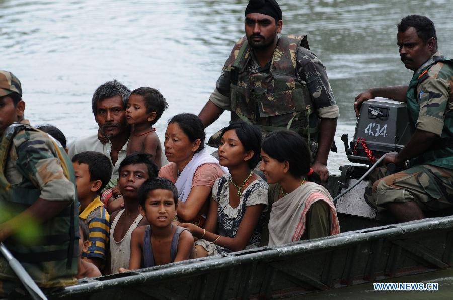 Indian army evacuate flood affected villagers to higher ground in Sootia, the worst flood affected Sonitpur district of northeastern state Assam, India, on July 3, 2012. At least 81 people have died and 2.2 million were forced to leave their homes over the last week as torrential monsoon rains trigger floods across India's northeast, officials said. (Xinhua) 