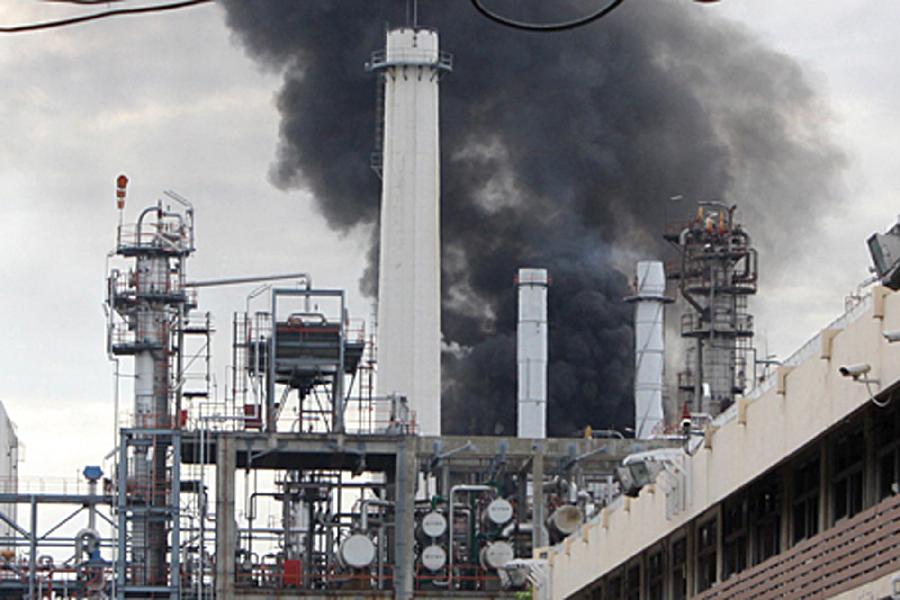 Black smoke rises after an explosion at the Bangchak oil refinery and depot in Bangkok, Thailand, July 4, 2012.