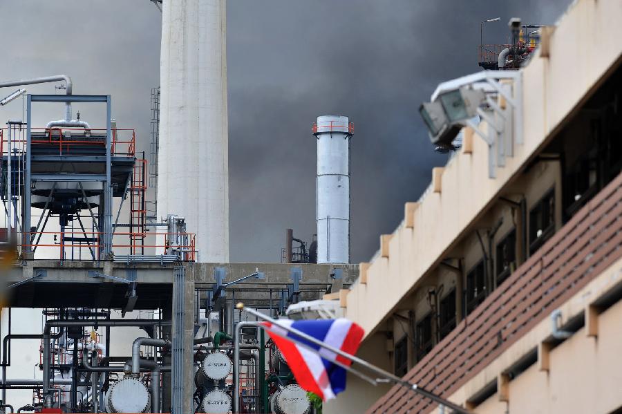 Black smoke rises after an explosion at the Bangchak oil refinery and depot in Bangkok, Thailand, July 4, 2012. 