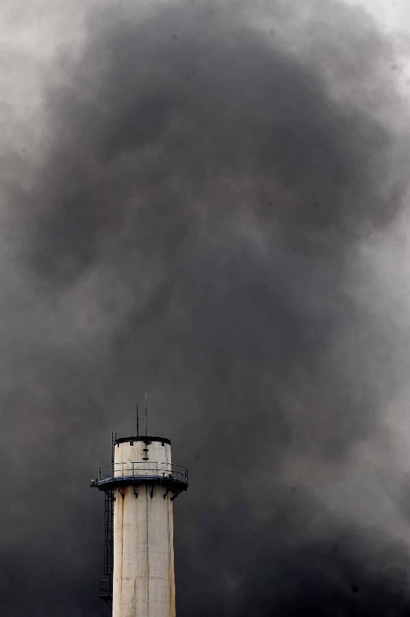 Black smoke rises after an explosion at the Bangchak oil refinery and depot in Bangkok, Thailand, July 4, 2012. 