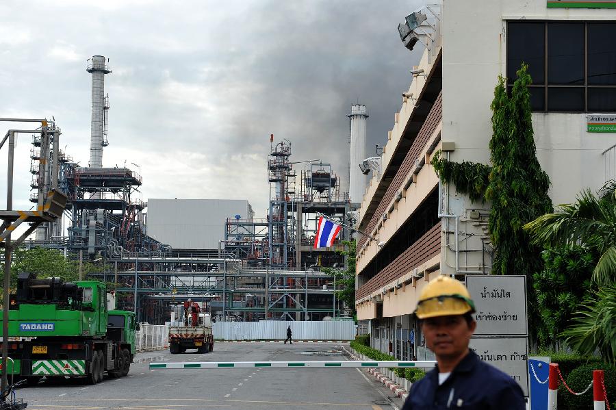 Black smoke rises after an explosion at the Bangchak oil refinery and depot in Bangkok, Thailand, July 4, 2012. 