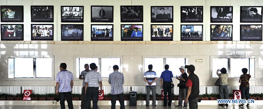 Tourists visit a locomotive at the scenic resort of Sino-Russian border gate in Manzhouli, north China's Inner Mongolia Autonomous Region, July 3, 2012