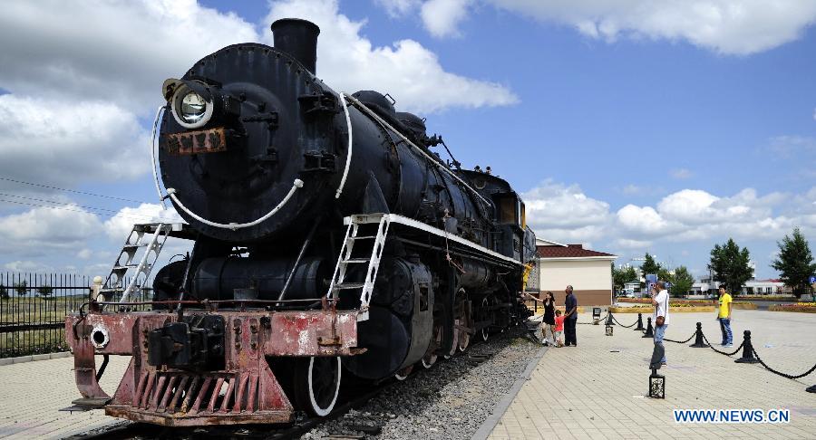 Tourists visit a locomotive at the scenic resort of Sino-Russian border gate in Manzhouli, north China's Inner Mongolia Autonomous Region, July 3, 2012ORDER GATE-TOURISM (CN)