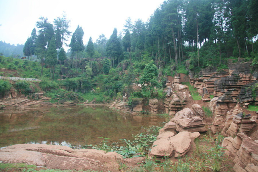 Human pond in Red Rocks National Geopark. It is located in Guzhang County of central China's Hunan Province. As China's only red carbonate rock forest, its history could be traced back 450 million years ago. 