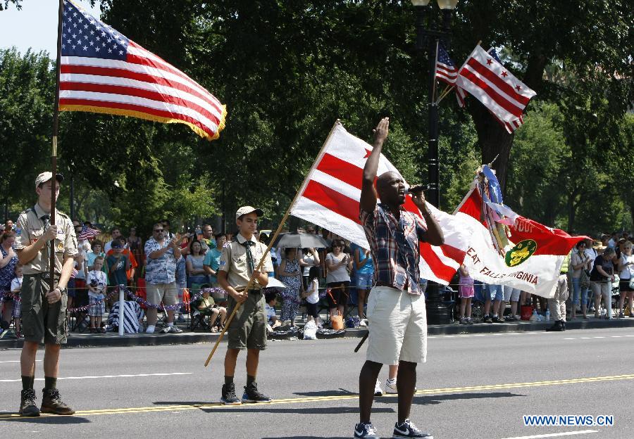 A man sings the U.S. national anthem during the Independence Day parade celebrating the United States' Fourth of July Independence Day holiday in Washington D.C. July 4, 2012. (Fang Zhe) 