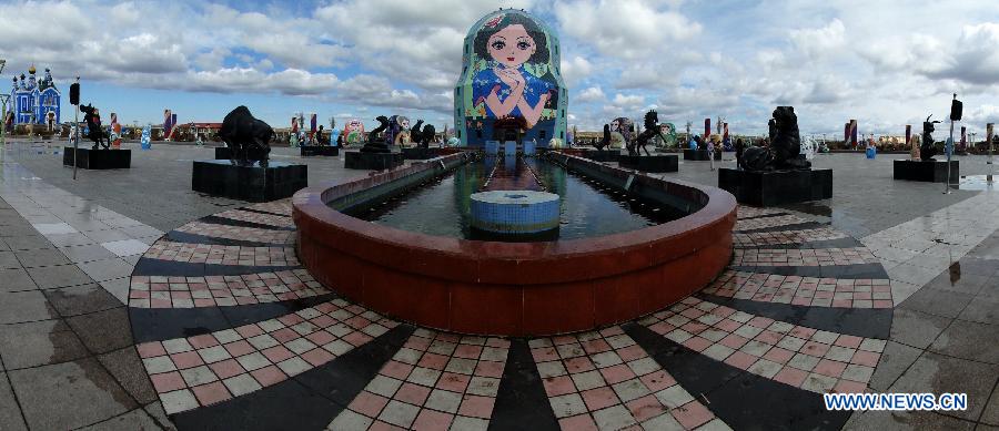 Photo taken on July 3, 2012 shows a statue of musicians surrounded by Russian style architecture in Manzhouli city, north China's Inner Mongolia Autonomous Region