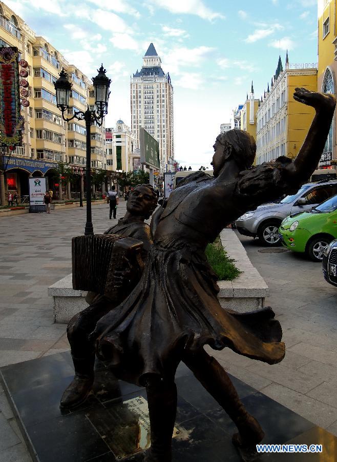 Photo taken on July 3, 2012 shows a statue of musicians surrounded by Russian style architecture in Manzhouli city, north China's Inner Mongolia Autonomous Region