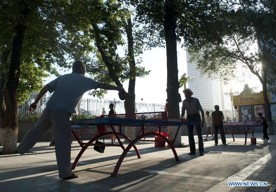 Citizens do morning exercises at a park in Urumqi, capital of northwest China's Xinjiang Uygur Autonomous Region, July 2, 2012