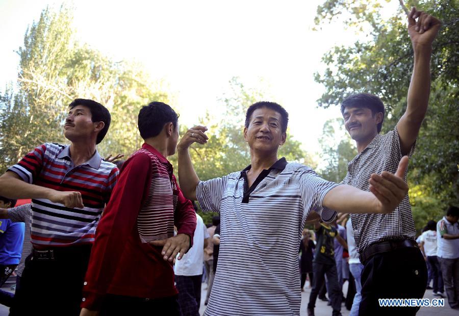 Citizens dance at a park in Urumqi, capital of northwest China's Xinjiang Uygur Autonomous Region, July 2, 2012