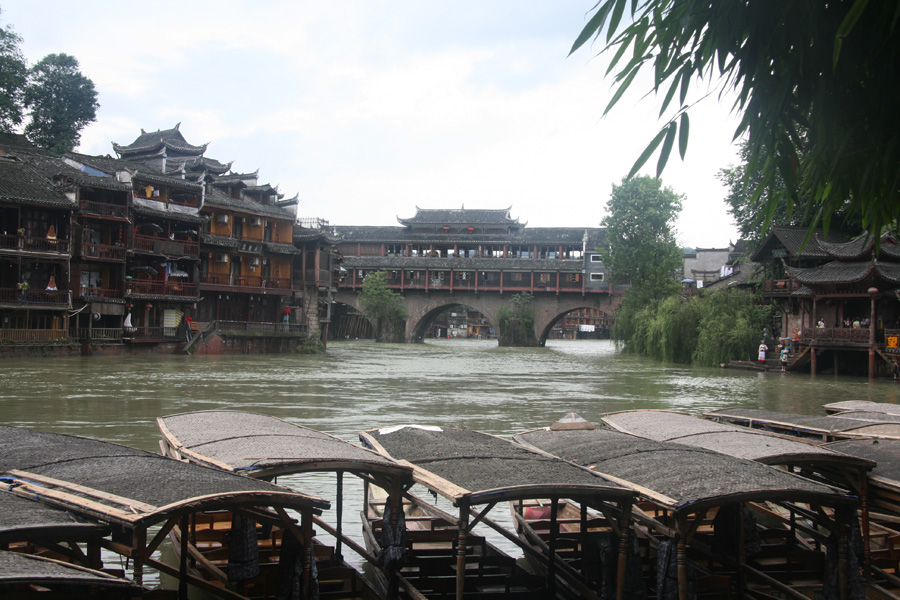 Boats wait in the queue on the riverbank of Fenghuang (Phoenix) ancient town in central China’s Hunan Province on June 28. Phoenix Town's history can be traced back to the Qin Dynasty (221-206BC). This town, according to New Zealand writer Rewi Alley, is one of the two most picturesque small towns in China, with colorful and hospitable people. [CnDG by Jiao Meng]