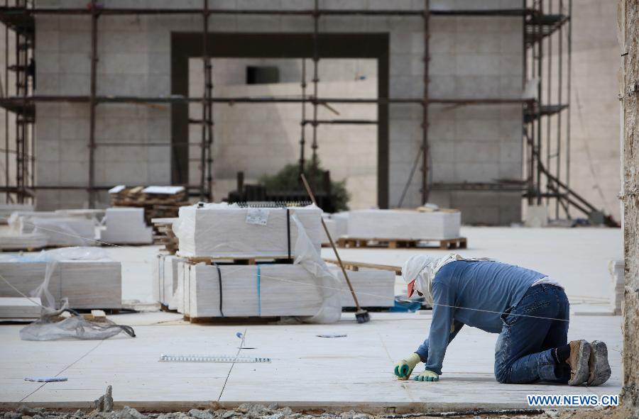 A Palestinian worker cleans the bricks of the mausoleum built over the grave of the late Palestinian leader Yasser Arafat in West Bank City of Ramallah on July 5, 2012. The Palestinian National Authority (PNA) has agreed to exhume late President Yasser Arafat's body for examination upon a request of some of his family members, a spokesman said Wednesday. (Xinhua/Chen Xu)