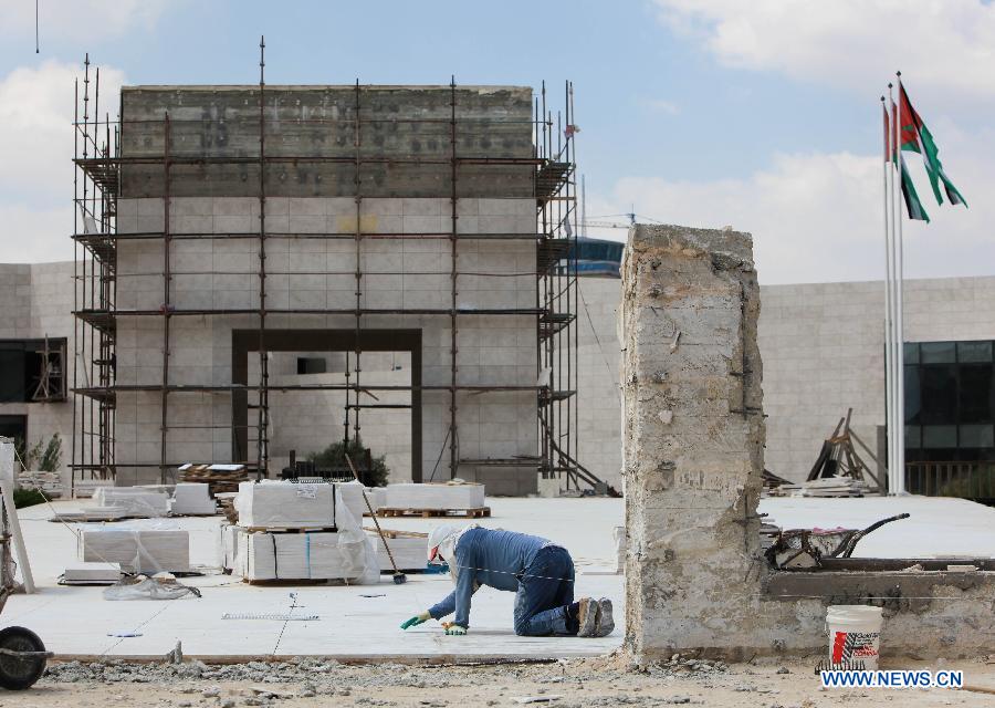 A Palestinian worker cleans the bricks of the mausoleum built over the grave of the late Palestinian leader Yasser Arafat in West Bank City of Ramallah on July 5, 2012. The Palestinian National Authority (PNA) has agreed to exhume late President Yasser Arafat's body for examination upon a request of some of his family members, a spokesman said Wednesday. (Xinhua/Chen Xu)