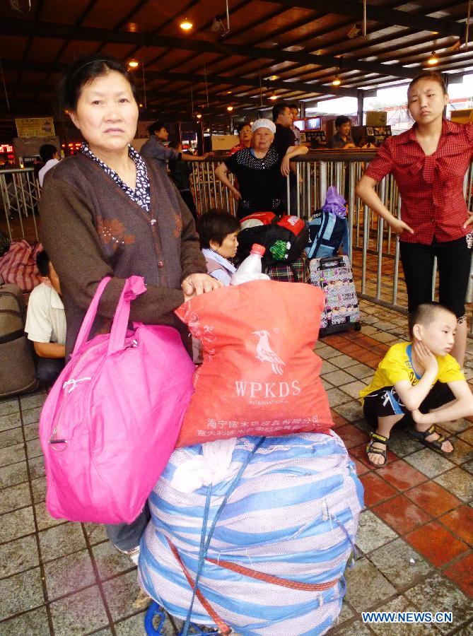 Passengers are seen at the railway station in Dazhou, southwest China's Sichuan Province, July 5, 2012. 