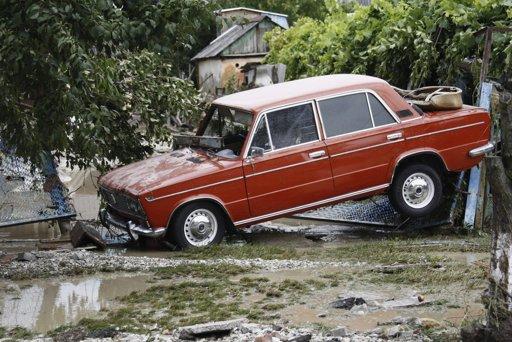 A stranded car is seen in a recently flooded street in the southern Russian town of Krymsk July 7, 2012.