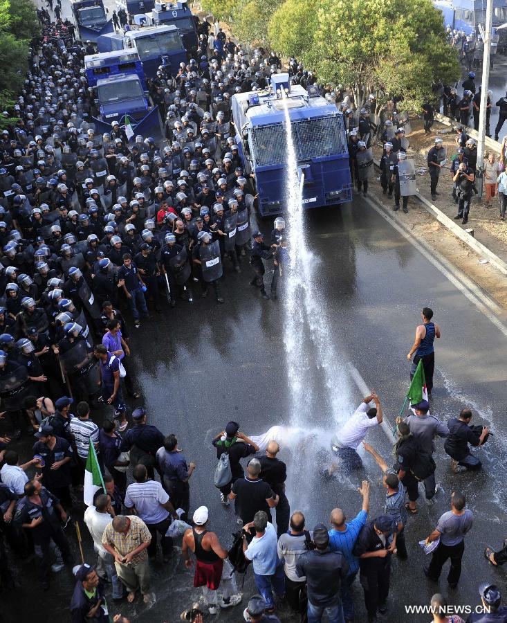 Riot police clash with community police during a demonstration in the neighbourhood of Bir Khadem in southern Algiers, capital of Algeria, on July 9, 2012. At least 5,000 members of the community police tried to go to the Presidency of the Republic to demand more socio-professional rights from the government. (Xinhua/Mohamed Kadri) 